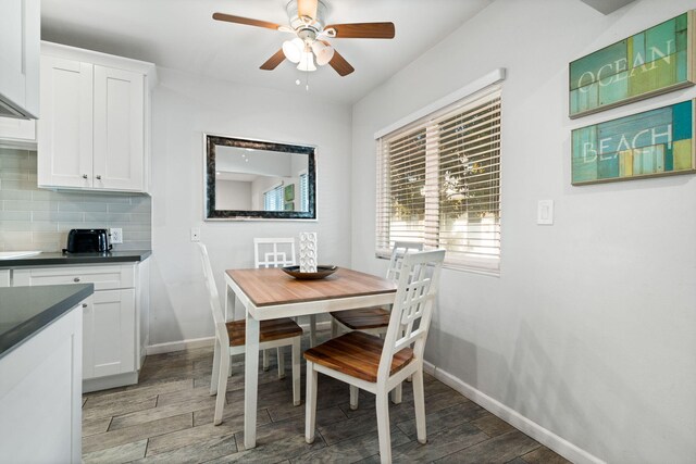 dining area featuring ceiling fan and dark hardwood / wood-style flooring