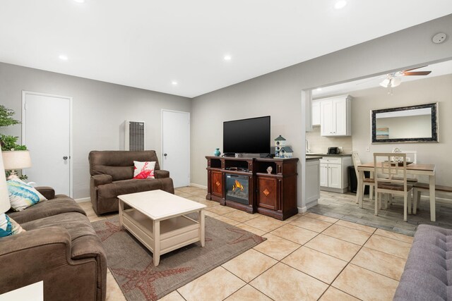 tiled living room featuring ceiling fan