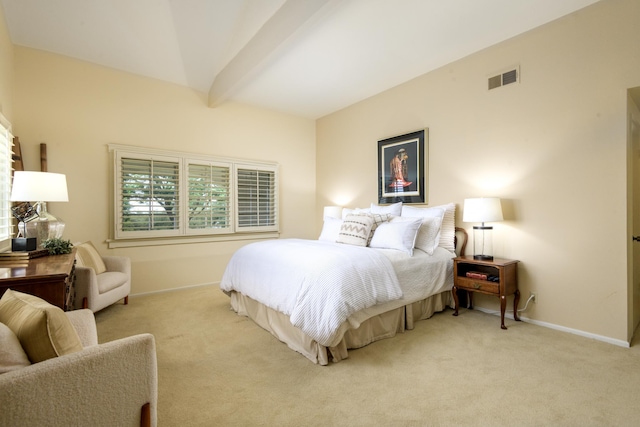 carpeted bedroom with beamed ceiling