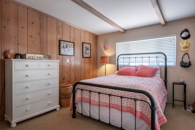 bedroom with light carpet, beamed ceiling, and wooden walls