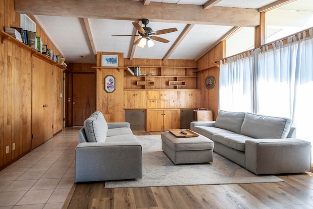 living room featuring light hardwood / wood-style flooring, a wealth of natural light, and wooden walls