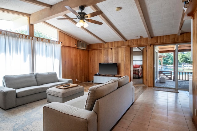 tiled living room featuring vaulted ceiling with beams, wood walls, an AC wall unit, and ceiling fan