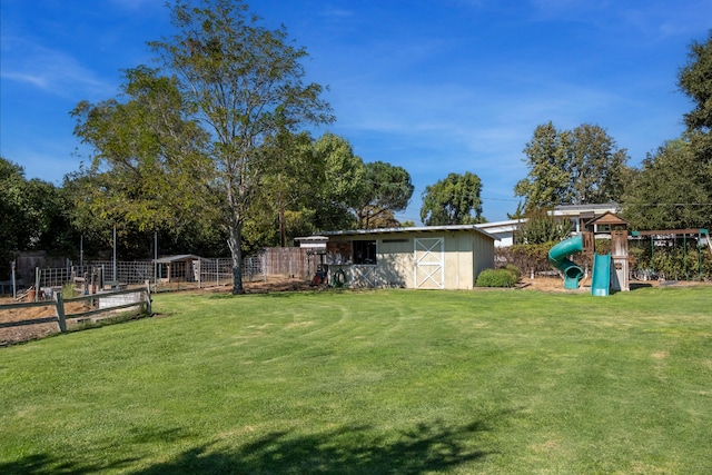 view of yard with a shed and a playground