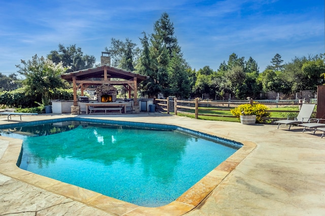 view of swimming pool with a gazebo, a patio area, and a diving board