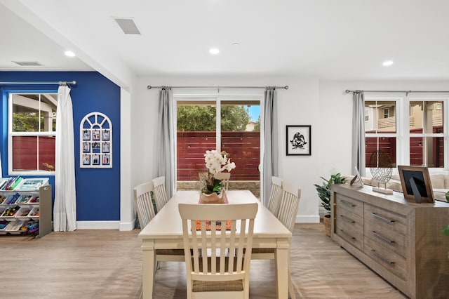 dining space featuring light hardwood / wood-style floors and a healthy amount of sunlight