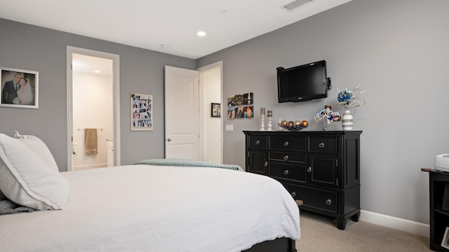 carpeted bedroom with ensuite bath