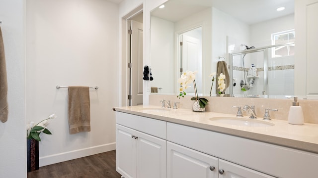 bathroom featuring vanity, wood-type flooring, and walk in shower