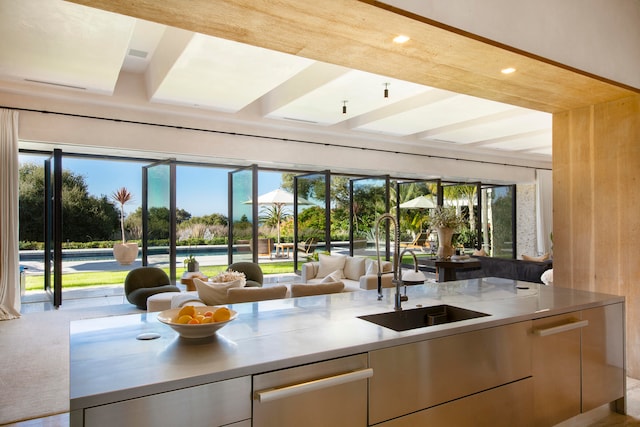 kitchen with light stone countertops, sink, plenty of natural light, and dishwasher