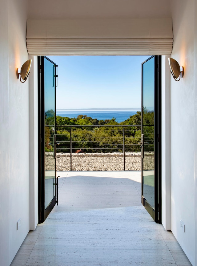 view of patio / terrace with a balcony and a water view