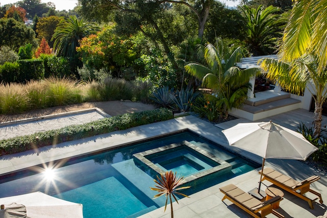 view of swimming pool with an in ground hot tub and a patio area