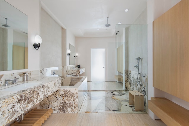 bathroom with hardwood / wood-style floors, vanity, and a shower