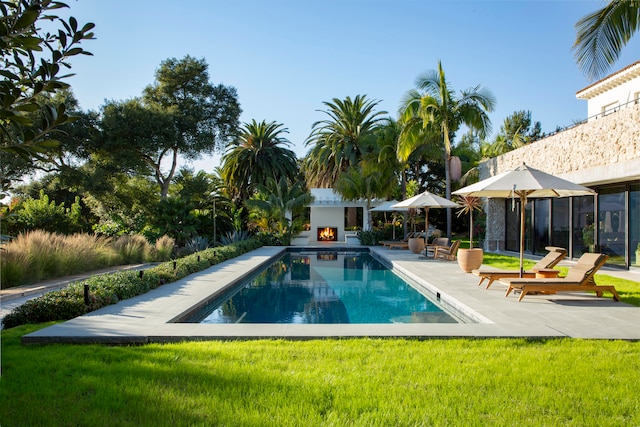 view of swimming pool featuring a yard and a patio