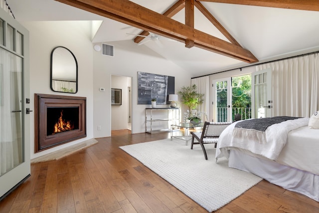 bedroom featuring dark hardwood / wood-style floors, access to outside, beam ceiling, high vaulted ceiling, and ceiling fan