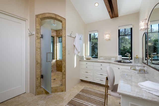 bathroom with vanity, a shower, and vaulted ceiling