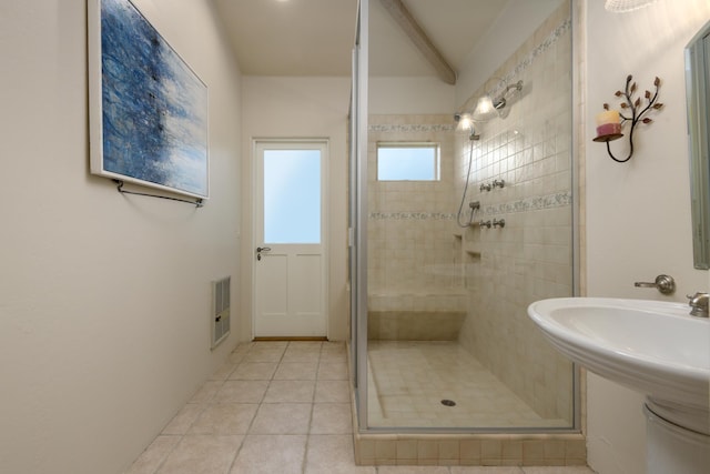 bathroom with tile patterned floors, heating unit, and an enclosed shower