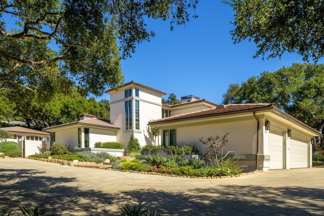 840 Ivy Ln, Santa Barbara, CA 93108 - mediterranean / spanish-style home with a garage, driveway, a tiled roof, a chimney, and stucco siding