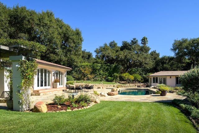 view of yard featuring a patio and an outbuilding