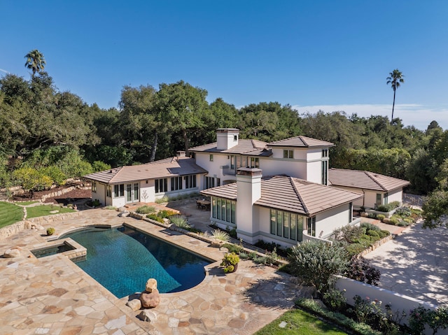 view of pool with a patio and an in ground hot tub