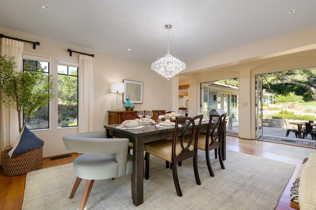 dining room with an inviting chandelier and light wood-type flooring