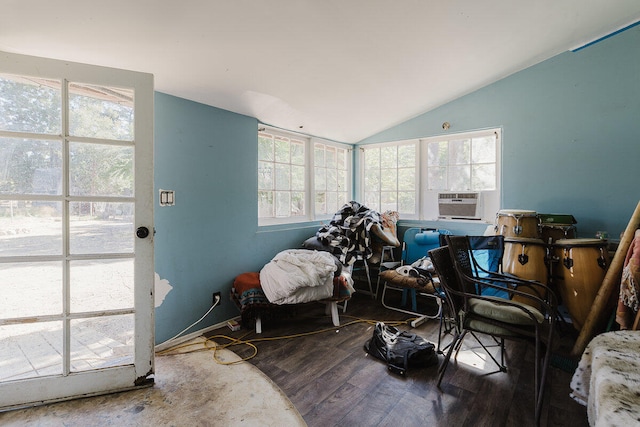 interior space featuring hardwood / wood-style flooring, cooling unit, and vaulted ceiling