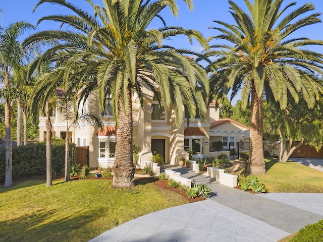 mediterranean / spanish-style home featuring a front yard