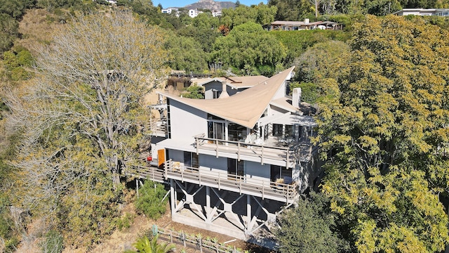 drone / aerial view featuring a wooded view