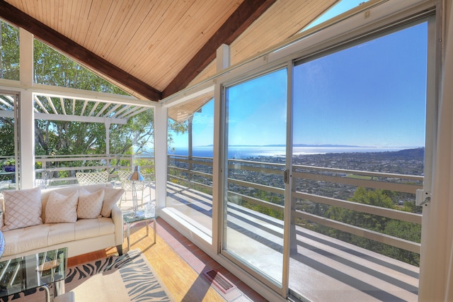 sunroom / solarium with wood ceiling, visible vents, vaulted ceiling, and a wealth of natural light