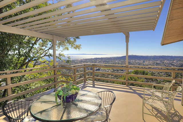 view of patio / terrace with a balcony and a pergola