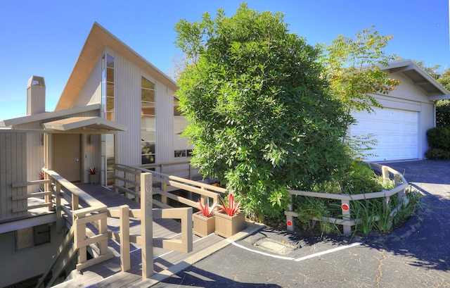 view of front of house featuring a garage and a deck