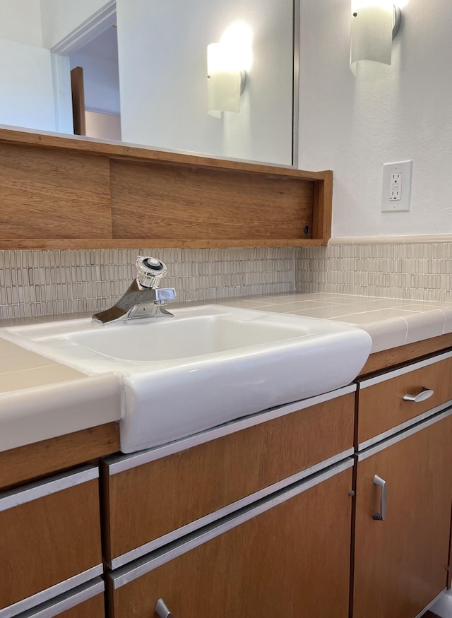 bathroom featuring vanity and decorative backsplash