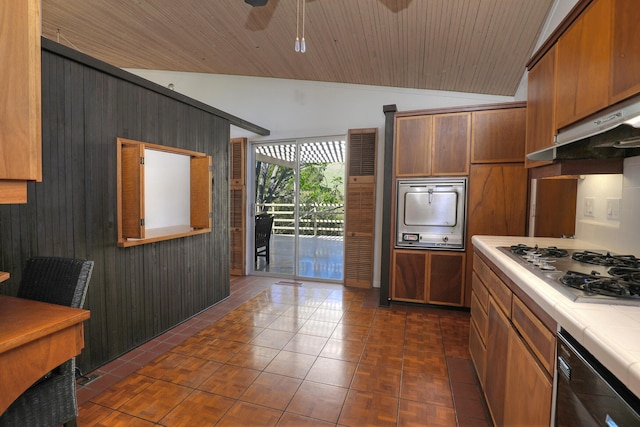 kitchen with tile countertops, lofted ceiling, ceiling fan, stainless steel cooktop, and dark tile patterned floors