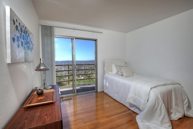 bedroom featuring wood finished floors and visible vents