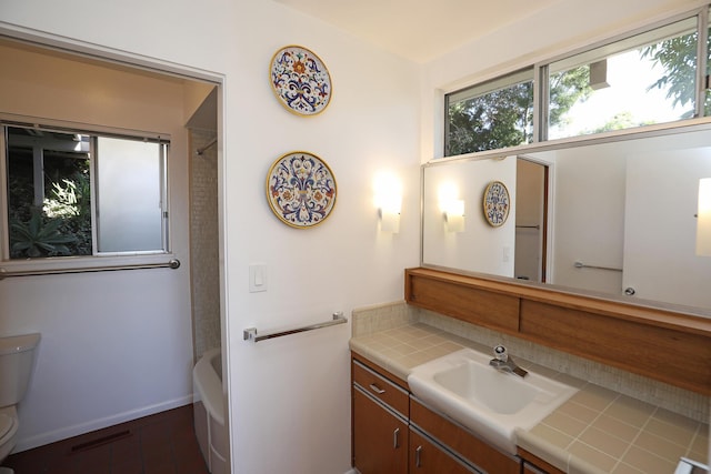 bathroom with baseboards, visible vents, vanity, and toilet