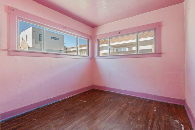 unfurnished room featuring dark hardwood / wood-style flooring