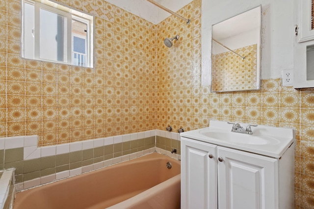 bathroom featuring vanity, tiled shower / bath combo, and tasteful backsplash