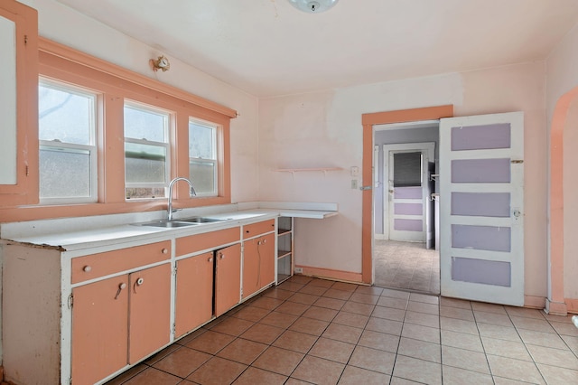 kitchen featuring sink and light tile patterned flooring