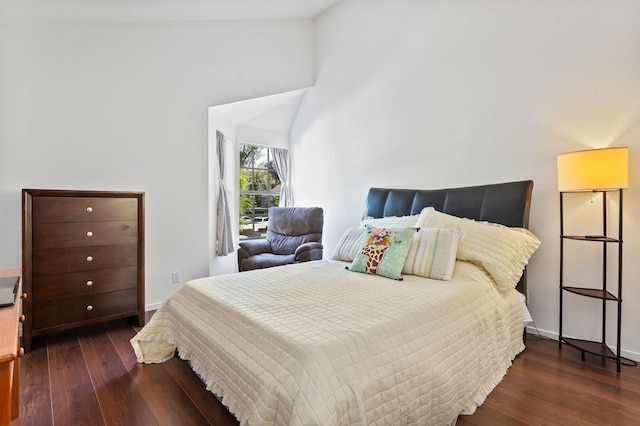 bedroom featuring high vaulted ceiling and dark hardwood / wood-style floors