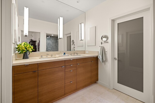 bathroom with walk in shower, vanity, and tile patterned floors