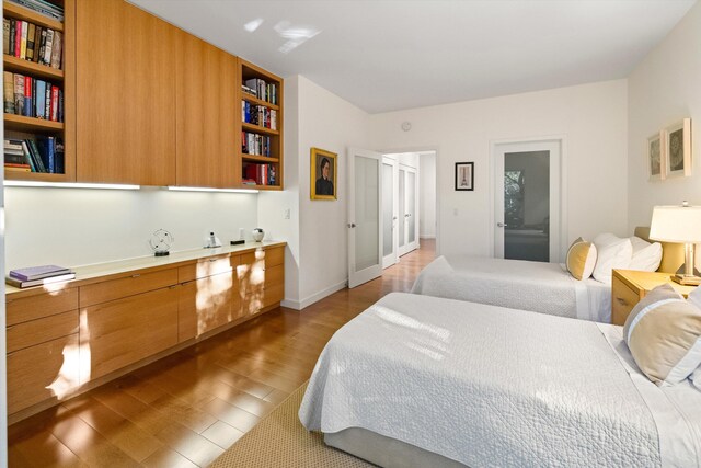 bedroom with light wood-style floors and baseboards