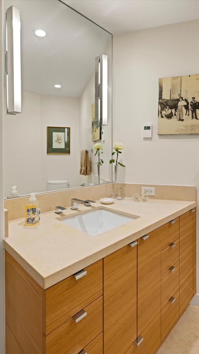 bathroom with recessed lighting, vanity, toilet, and tile patterned floors