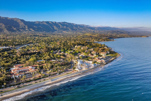 drone / aerial view featuring a water and mountain view