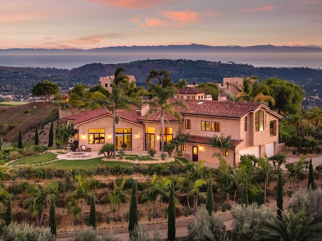 back house at dusk featuring a mountain view