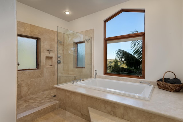 bathroom featuring tile patterned floors and separate shower and tub