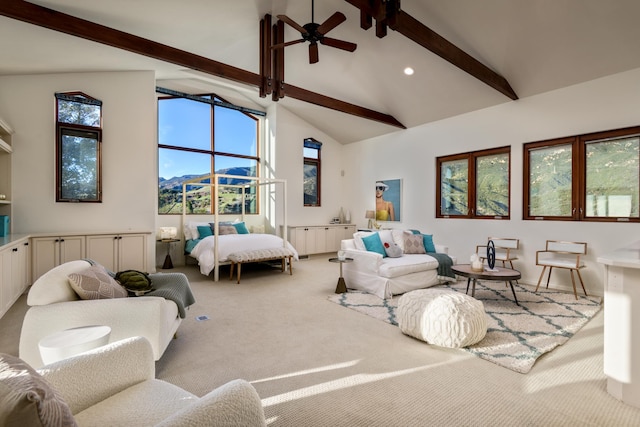 carpeted living room featuring beamed ceiling, a mountain view, high vaulted ceiling, and ceiling fan