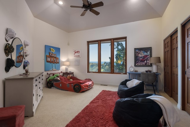 bedroom featuring ceiling fan, lofted ceiling, and light colored carpet