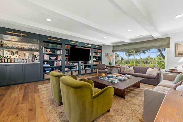 living room with beam ceiling and light hardwood / wood-style floors