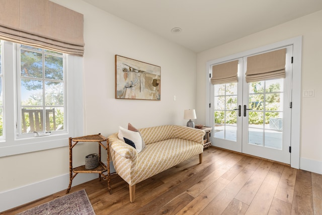 sitting room featuring hardwood / wood-style floors and french doors