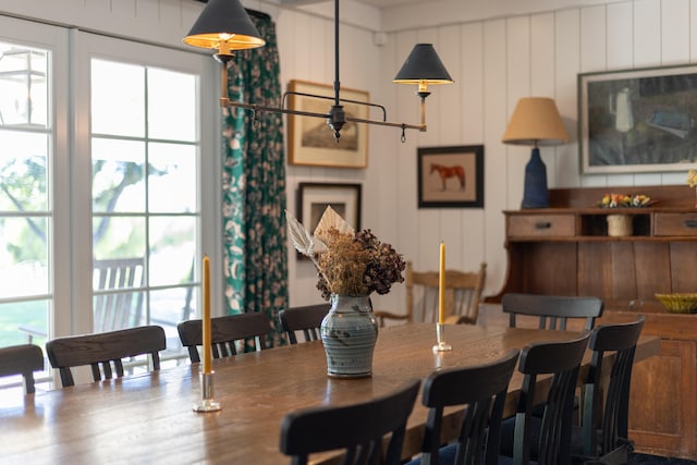 dining area featuring wooden walls