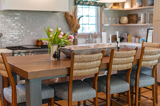 kitchen featuring ventilation hood and backsplash