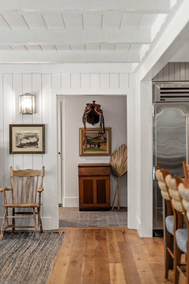 hall featuring beam ceiling, wooden ceiling, and hardwood / wood-style floors